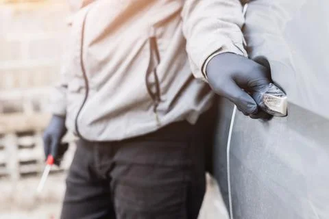 The thief pull up the door handle to Stealing a car. The vehicle insurance .. Stock Photos