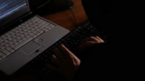 Thief, technical genius, fraudster, hacker steals cryptocurrency at night Stock Footage 167944489
