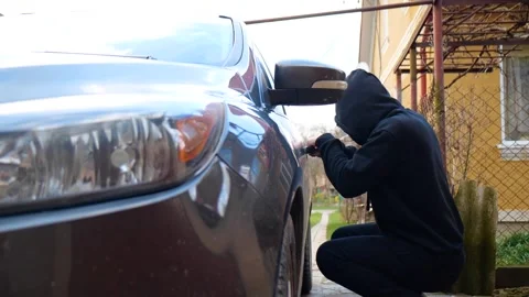 The thief tries to open the car Stock Footage 271069380