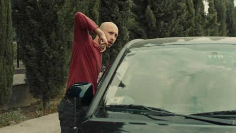 Thief trying to steal a car while looking Stock Footage 283066481