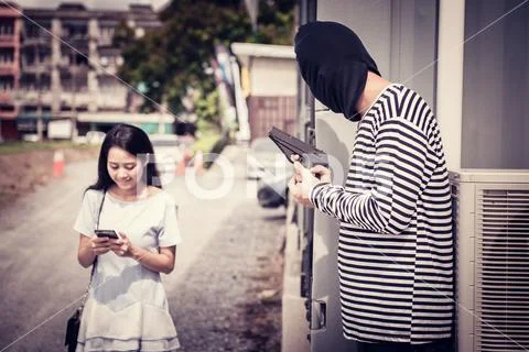 Thief is trying to steal at the public place Stock Photos