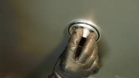 Thief Unlocking Combination to Safe Stock Footage 70397486
