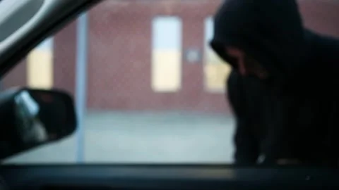 Thief using a device to try and steal a parked vehicle Stock Footage 252044372