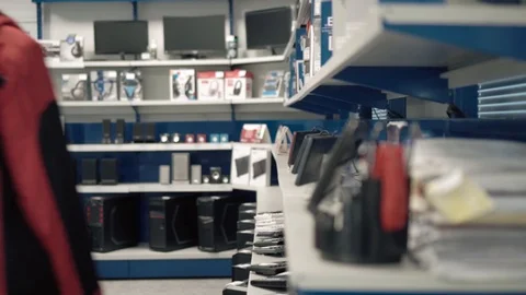 Thieves girl steals keyboard in computer store Stock Footage 98450720