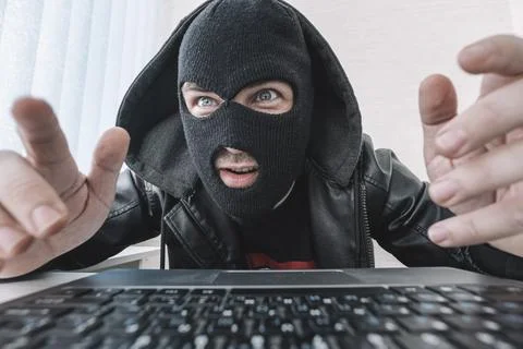 Thieves hold credit cards using laptop computer for password hacking activi.. Stock Photos