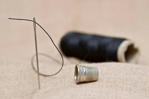 Thimble and needle. Stock Photos