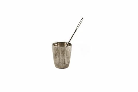 Thimble and needle. On a white background close-up. For sewing. Stock Photos