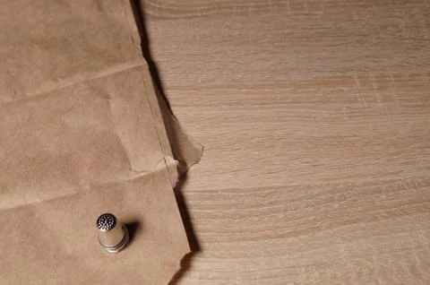 Thimble on a wooden table Stock Photos