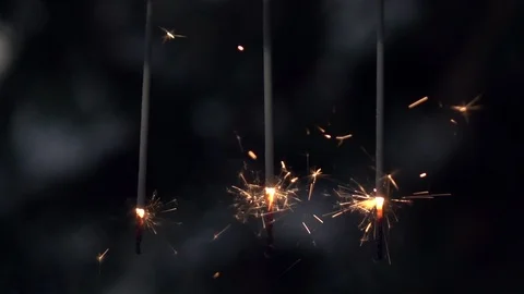 Thin and weak Bengal or Indian lights, or sparklers, burning in slow motion. Stock Footage 86429611
