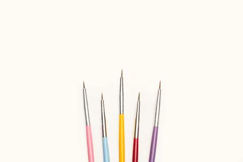 Thin artistic paintbrushes on a white background with copy space 스톡 사진