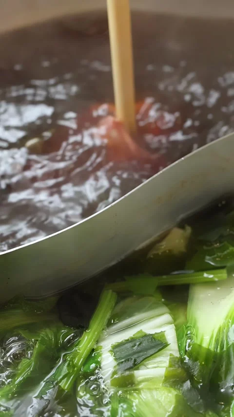 Thin Beef Slice Cooking in Dual Broth Hotpot Stock Footage 324027320