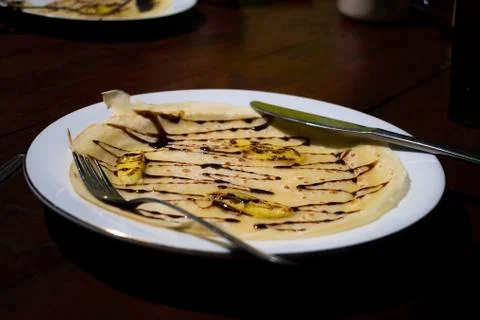 Thin Breakfast pancake served on the table with tomato sauce in a white plate Stock Photos