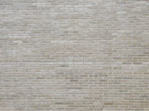 A thin brick wall with a grayish tint. background, texture Stock Photos