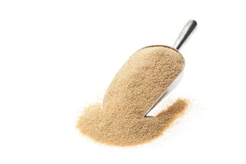 Thin bulgur in silver tin scale spoon on white background. food 写真素材