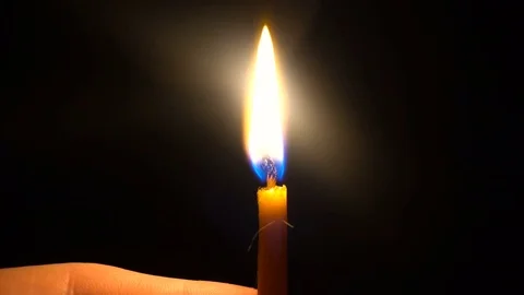 Thin Candle blown out in hands of a young man Video stock 73890987