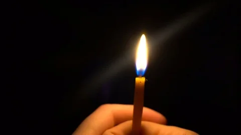 Thin Candle blown out in hands of a young man Stock Footage 73892169