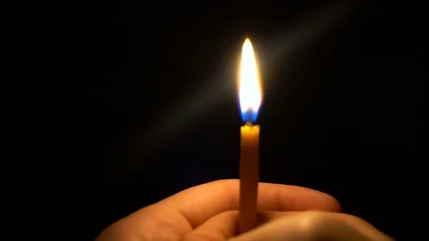 Thin Candle blown out in hands of a young man Video stock 73893053