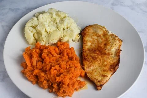 Thin chicken breast  with mashed potatos and carrots Stock Photos