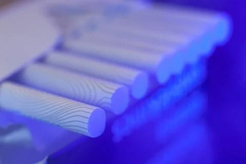 Thin cigarettes with a filter in blue light, smoking causes heart attacks Stock Photos