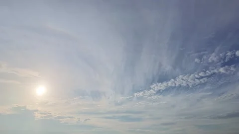 Thin cirrus clouds and sun in blue sky. Stock Footage 345484955