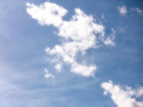 Thin Cloud Streaks and Small Cloud Patches in Blue Sky Stock Photos