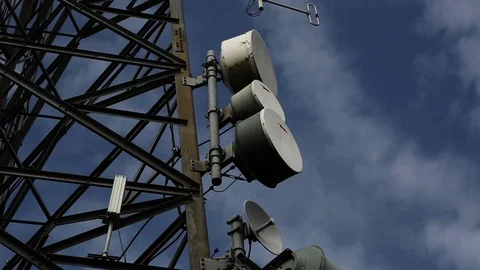 Thin Clouds Swirl around a Communications Tower via Timelapse Stock Footage 89236318
