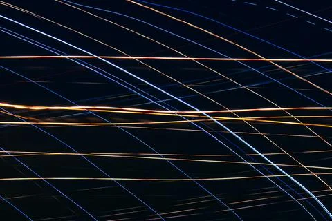 Thin colored stripes on a black background. Background with blue and yellow l Stock-Fotos
