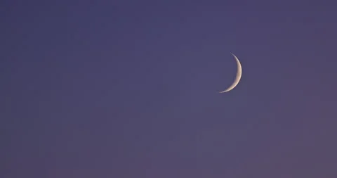 Thin crescent moon shining in the dark twilight sky with stars Stock Footage 338421352