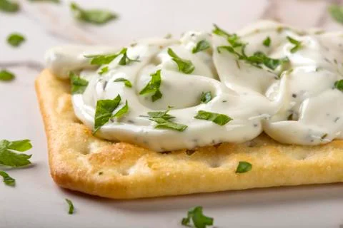 Thin crispy crackers with cream cheese and parsley Stock Photos