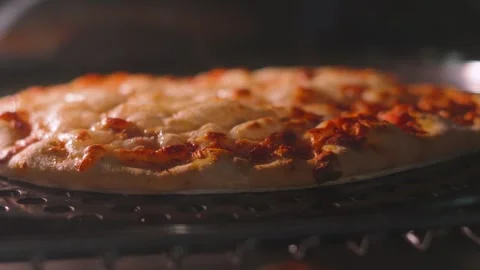 Thin Crust Cheese and Tomato Pizza Bubbling Slowly Whilst Cooking in Oven. Stock Footage 338412889
