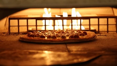 Thin crust pizza baked in live fire stone or brick oven 1 Stock Footage 123874953