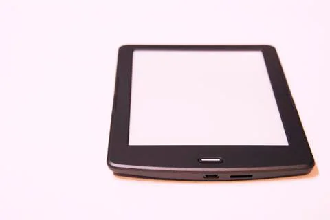 Thin e-book with touch screen on white background.Replacing paper books. Stock Photos