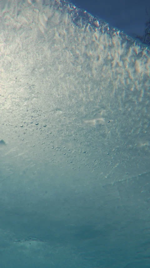 Thin edge of spring ice moving downstream on blue sky background on sunny day Stock Footage 316538617