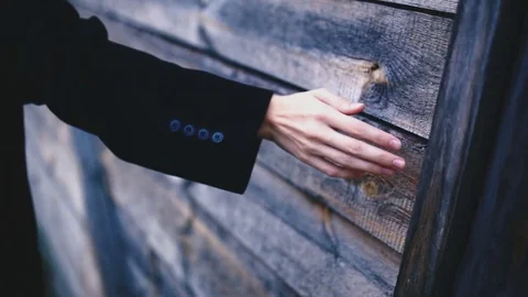 The thin female hand on a background of a wooden house Stock Footage 72923853