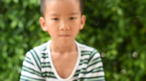 Thin focus on hand, Child holding young seedling plant in hands on green backgro 库存影片 61801899