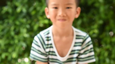Thin focus on hand, Child holding young seedling plant in hands on green backgro 库存影片 62012955