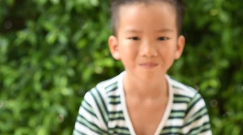 Thin focus on hand, Child holding young seedling plant in hands on green backgro Stock Footage 62012957