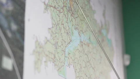 Thin foldable pointer smoothly moves across paper map Stock-Footage 327808350