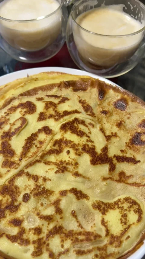 Thin fried pancakes, two glasses of coffee Stock Footage 324009662