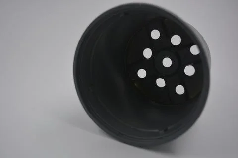 Thin gray plastic flower pot, the container is arranged on a white plastic. Stock Photos