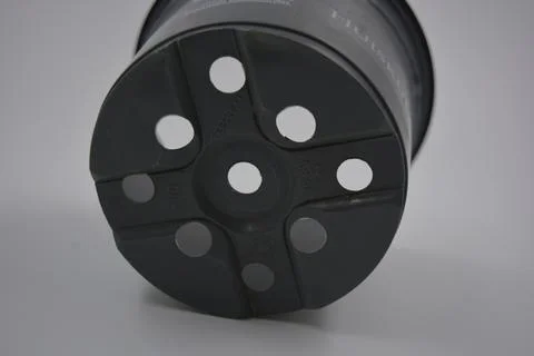Thin gray plastic flower pot, the container is arranged on a white plastic. Stock Photos