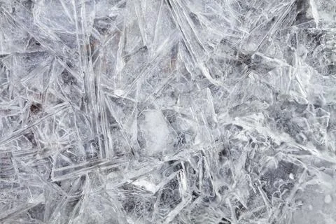Thin ice consisting of an interweaving of large crystals Stock Photos