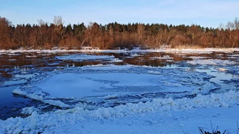 Thin Ice Sheet Drifting Down Winter River Video Frame Video stock 325449459