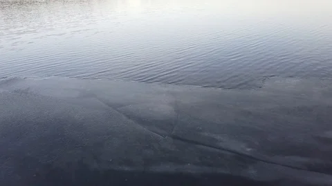 Thin layer of ice when the lake start freezing over, Finland Stock Footage 122202001