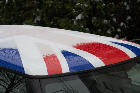 A thin layer of snow and large drops of water lie on the roof of the car, win Stock Photos
