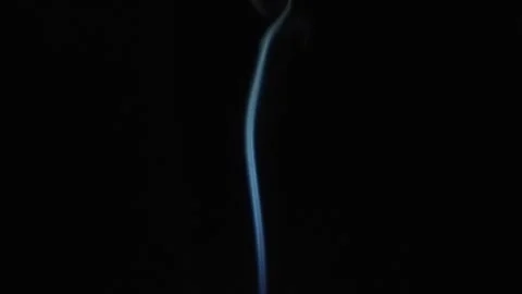 Thin line of smoke in slowmo moving in dark Stock Footage 228835877