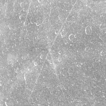 Thin lineaments cross back and forth, intersecting craters on the surface ... Stock Photos