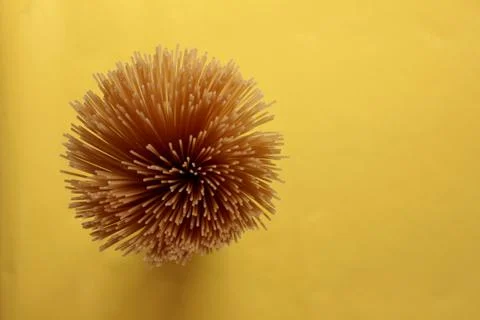 Thin long spaghetti on a yellow background with copy space. Foto stock