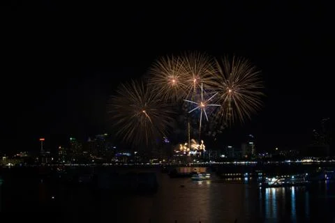 Thin long tail fireworks on beach and reflection color on water surface 写真素材