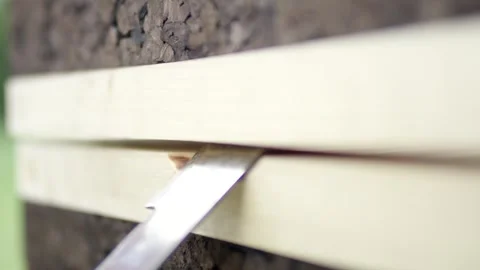 Thin Metal Blade Sliding Into Gap of Stacked Wooden Boards, Macro Detail Stock Footage 341296608
